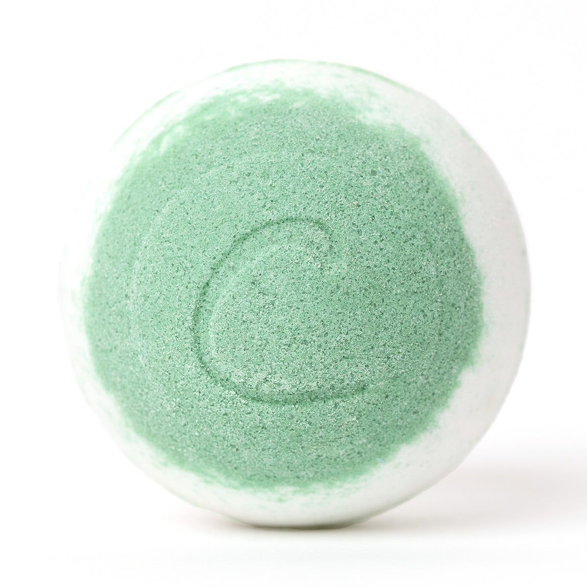 Round white and lime green bath bomb with a textured surface and a subtle letter C embossed on the front.